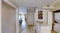 Located at 3695 Island Club Drive in North Port, Florida, this single-floor, 2-bedroom, 2-bathroom unit offers a well-designed layout across a comfortable footprint. The open-concept living and dining area is bright and welcoming, featuring wood-look flooring, ceiling fans, and large windows with sliding glass door access to a private balcony that brings in generous natural light. The dining area is a defined space with neutral walls, ideal for everyday meals or entertaining.

The kitchen is fully equipped with stainless steel appliances — including a refrigerator, range, over-the-range microwave, and dishwasher — complemented by white cabinetry, tile backsplash, and light countertops. A stacked washer and dryer unit is conveniently tucked nearby for in-unit laundry access.

The spacious primary bedroom features plush carpet, a ceiling fan, and a bright window with outdoor views. The second bedroom is equally comfortable with recessed lighting and carpeted flooring. Two full bathrooms serve the unit: one with a tub/shower combo and the other with a standalone shower, both finished with tile flooring and clean white fixtures. A dedicated closet adds practical storage to complete this thoughtfully arranged home.