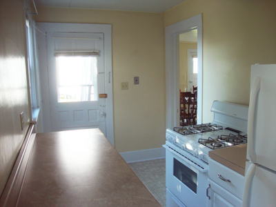Kitchen toward back door and dining room doorway. - 225 College Ave