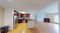 Located at 1920 Dunlap Cres in Chester, VA, this single-floor home offers a well-designed open-concept layout that seamlessly connects the kitchen, dining, and living areas. The kitchen is a standout feature, showcasing rich cherry wood cabinetry, granite countertops, and a full suite of stainless steel appliances including an electric range, built-in microwave, and refrigerator. A central island with pendant lighting adds both functionality and style, while hardwood flooring flows throughout the main living spaces, adding warmth and continuity.

The living area benefits from vaulted ceilings that create an airy, expansive feel, complemented by a glass-paned door that invites natural light. Bedrooms are carpeted for comfort and feature multiple windows with blinds, providing ample natural light and a bright, neutral atmosphere.

The home includes two full bathrooms, each finished with tile flooring, a tub/shower combination, and rich wood vanities with light countertops. One bathroom features a large mirror with vanity lighting. Overall, the home presents a clean, functional interior with consistent finishes throughout, making it a practical and inviting single-level residence in Chester, Virginia.