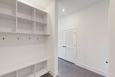 Located in Birmingham, AL, this thoughtfully designed 2-bedroom, 3-bathroom residence offers a clean, modern aesthetic across a single floor. The open-concept living, dining, and kitchen area is bathed in natural light through large windows that frame sweeping city views, complemented by hardwood-style flooring and a ceiling fan overhead. The kitchen features a central island with pendant lighting and dark cabinetry, flowing seamlessly into the living and dining spaces.

Both bedrooms are carpeted and bright, with ceiling fans and windows offering city views. The primary bedroom is generously sized and includes direct access to a private bathroom and a dedicated walk-in closet, providing ample storage. A standout feature of the space is the built-in mudroom area, complete with open shelving, hooks, and a bench — ideal for organization. Louvered double doors add a classic touch nearby.

All three bathrooms are finished with striking marble-look tile surrounds on the tub and shower areas, paired with matte black fixtures that deliver a contemporary, upscale feel. Additional amenities include a laundry area, multiple closets throughout, a patio, and a hallway connecting the well-planned layout. The consistently white walls and modern finishes create a bright, cohesive atmosphere throughout.