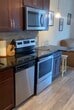 Welcome to effortless, elevated living at 1935 Second St SW in the heart of Rochester, MN. This beautifully appointed 400-square-foot studio is your opportunity to embrace a refined urban lifestyle without compromise.

Step inside and be immediately drawn to the stunning kitchen — a true centerpiece of the home. Rich, dark cabinetry pairs elegantly with gleaming granite countertops and a striking stacked-stone tile backsplash, creating an atmosphere that is both warm and sophisticated. A full suite of stainless steel appliances, including a range, microwave, dishwasher, and refrigerator, ensures that every culinary endeavor is a pleasure. Pendant lighting casts a warm glow, setting the perfect ambiance for intimate dinners or morning coffee rituals.

The open living area is bathed in natural light, courtesy of expansive floor-to-ceiling sliding glass doors that lead directly to your private balcony. Step outside and soak in sweeping views of the Rochester skyline and lush green treetops — your own personal escape above the city's energy. The durable, stylish wood-look flooring flows seamlessly throughout, lending a contemporary elegance to every corner.

A full bathroom with a tub/shower combo completes this thoughtfully designed space, ensuring every comfort is at your fingertips. Whether you're a young professional, a savvy investor, or someone seeking a low-maintenance lifestyle in a vibrant community, this residence delivers the perfect blend of style, function, and location. Live boldly. Live beautifully.