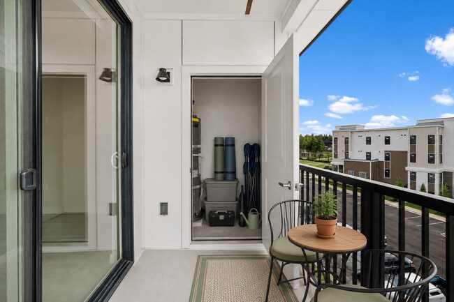 Staged balcony illustrating space for outdoor seating and organized storage - 27 West Apartments