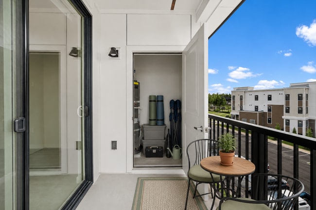Staged balcony illustrating space for outdoor seating and organized storage - 27 West Apartments