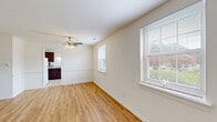 Located at 1414 Newell Rd in Richmond, Virginia, this single-floor, 2-bedroom, 1-bathroom home offers a practical and well-organized layout across a comfortable footprint. The living room greets you with warm, light-toned hardwood-style flooring, crisp white walls, and a window that invites natural light, creating a bright and welcoming atmosphere. A hallway connects the main living areas to the private quarters of the home. The kitchen is a functional highlight, featuring rich dark-wood cabinetry, granite-look countertops, tile flooring, a gas range, dishwasher, refrigerator, and a window overlooking the outdoors — providing both utility and a pleasant cooking environment. Both bedrooms are carpeted in neutral tones, offering a comfortable feel underfoot. The spacious primary bedroom includes a built-in closet with sliding doors, while the second bedroom also benefits from natural light through a window with blinds. Each bedroom is finished with clean white walls and flush-mount ceiling lighting. The full bathroom is efficiently designed, featuring a shower/tub combination, toilet, and vanity. The overall aesthetic throughout the home is clean, neutral, and move-in ready, making it a practical and comfortable residence in Richmond.