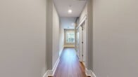 This 630 square foot apartment offers a thoughtful single-floor layout, maximizing space efficiency. The heart of the home is a combined kitchen and living room area, promoting an open and airy feel. The sole bedroom, measuring 160 square feet, provides a comfortable private retreat. Notably, the apartment features two bathrooms, an uncommon luxury for its size, enhancing convenience for residents and guests alike.

The interior showcases a modern aesthetic with clean lines and a neutral color palette. Warm wood flooring extends throughout, adding a touch of natural warmth and continuity to the space. Recessed lighting in the ceiling contributes to the contemporary ambiance while providing even illumination.

The apartment's design incorporates practical elements such as a closet for storage and a hallway connecting the various rooms. White doors with louvered designs add a subtle textural element, contrasting nicely with the pale walls. Baseboards and crown molding provide refined finishing touches, elevating the overall look of the space.

While compact, this apartment's thoughtful layout and modern finishes create a welcoming and functional living environment, ideal for those seeking a contemporary urban lifestyle.