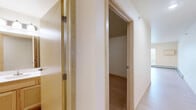 Located on First Ave N in Moorhead, Minnesota, this 1-bedroom, 1-bathroom unit offers a thoughtfully designed single-floor layout that makes efficient use of its space. Light-toned hardwood-style flooring runs throughout, creating a clean, cohesive aesthetic across every room.

The open-concept kitchen and living area serves as the heart of the unit. The kitchen is equipped with stainless steel appliances — including a refrigerator, range, built-in microwave, and dishwasher — complemented by light maple cabinetry and gray laminate countertops. Recessed lighting illuminates the space efficiently. The adjoining living area benefits from a large sliding glass door and an additional window, inviting generous natural light and outdoor views, while a baseboard heating system runs along the wall.

The bedroom is a well-sized, quiet retreat with neutral walls, its own baseboard heating, and multiple electrical outlets for flexible furniture arrangements. The full bathroom features a walk-in shower stall with a clean white surround. A dedicated laundry room includes a stacked washer and dryer unit along with built-in wire shelving, adding practical storage and convenience. Light wood trim and warm neutral wall tones throughout give the unit a bright, welcoming character.