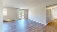 Located at 31 Campbell Court in Stratford, Ontario, this well-appointed 2-bedroom, 1-bathroom single-floor unit offers a clean, modern interior with thoughtful updates throughout. Light-toned vinyl plank flooring runs consistently across the living spaces, complemented by neutral-painted walls and textured ceilings that add subtle character. The living room is generously proportioned, featuring a sliding glass door that opens to a private balcony, allowing natural light to fill the space and providing pleasant outdoor views. The kitchen is efficiently designed in an L-shape layout, outfitted with crisp white cabinetry, stone-look countertops, a double stainless steel sink, and a full suite of stainless steel appliances including a refrigerator, electric range, built-in microwave, and dishwasher. Both bedrooms are well-sized, each featuring large windows that bring in natural light and baseboard heating units for year-round comfort. The primary bedroom includes a double-door closet offering ample storage. The bathroom is finished with white tile surround and a full soaker bathtub. A hallway connects all rooms in a functional layout, making efficient use of the available floor space throughout this move-in-ready home.