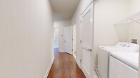 Located at 415 Rahway Ave in Westfield, NJ, this single-floor residence offers a thoughtfully designed layout with two bedrooms and three bathrooms across a generously sized floor plan. Warm hardwood flooring flows consistently throughout the living areas, bedrooms, hallway, and walk-in closet, creating a cohesive and inviting aesthetic.

The kitchen is outfitted with white shaker-style cabinetry, light gray quartz countertops, a mosaic tile backsplash, and a full suite of stainless steel appliances, including a gas range, microwave, and refrigerator. Light-toned tile flooring grounds the space cleanly. The adjacent living room benefits from large windows that draw in natural light and provide outdoor views.

The spacious primary bedroom features multiple windows, including a distinctive arched window, filling the room with bright, natural light. A dedicated walk-in closet with wire shelving provides ample storage. The second bedroom is also well-sized and naturally lit.

The bathrooms are finished with marble-style tile, glass-enclosed tub-shower combinations with sliding doors, and clean white vanities with dark countertops. The hallway connects all rooms efficiently, with louvered closet doors adding a classic architectural touch throughout.