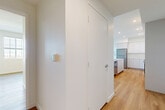 Located at 2700 N Perris Blvd in Perris, CA, this well-appointed two-bedroom, two-bathroom single-story residence offers a thoughtfully designed layout with a modern aesthetic. Light-toned hardwood flooring runs throughout the entire home, creating a cohesive and warm atmosphere.

The kitchen serves as the centerpiece of the space, showcasing sleek flat-panel white cabinetry extending to the ceiling for ample storage, stone-look countertops, a large waterfall island with an integrated sink, and a full suite of stainless steel appliances including a gas range, over-the-range microwave, refrigerator, and dishwasher. Recessed lighting illuminates the space efficiently.

A central hallway connects the bedrooms and bathrooms. The spacious primary bedroom features natural light through multiple windows with views of the surrounding area, complemented by a closet for storage. The second bedroom is comparably well-sized and bright. Both rooms feature clean white walls and the same warm wood flooring.

The two bathrooms maintain the home's clean, minimal style — one features a tiled walk-in shower, while the other offers a full soaking tub with shower combination, both finished with white tile and chrome fixtures. The overall design is modern, neutral, and move-in ready.