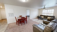 Located at Campus Pointe in Charleston, IL, this 2-bedroom, 3-bathroom single-floor unit offers a practical and well-organized layout. The combined kitchen and living room serves as the heart of the space, with the living area featuring carpet flooring, a ceiling fan, and a window that brings in natural light and outdoor views. A dining area sits adjacent, creating a seamless open flow between the two spaces.

The kitchen is equipped with warm-toned wood cabinetry, white appliances including a refrigerator, range, microwave, and dishwasher, and tile flooring that transitions neatly into the carpeted living area. A hallway connects the main living space to the private rooms.

Both bedrooms are carpeted and receive natural light through individual windows. Each room offers enough space to accommodate a bed and a desk, making them well-suited for functional use. Three closets are distributed throughout the unit for ample storage. An additional office provides flexible space for work or study.

All three bathrooms feature tile flooring, a tub-shower combination, and a clean, neutral aesthetic. The entry hallway provides a defined transition into the main living area.