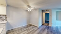 Located at 1417 North Vista Street in the heart of Los Angeles, this well-appointed one-bedroom, one-bathroom unit offers a thoughtfully designed layout across a single floor. Wood-style luxury vinyl plank flooring runs throughout, lending a cohesive and modern aesthetic to every room.

The combined kitchen and living area serves as the heart of the unit. The living room features a tiled fireplace as a standout focal point, neutral gray walls, and sliding glass doors that open to a private balcony, filling the space with natural light. The galley-style kitchen is fully updated with white shaker cabinetry, quartz countertops, a mosaic tile backsplash, stainless steel appliances including a gas range and built-in microwave, and recessed lighting beneath a tray ceiling.

The spacious primary bedroom offers generous proportions, cool-toned walls, a ceiling fan with light fixture, and its own sliding glass door providing additional outdoor access and natural light. A hallway connects the main living areas to the bathroom and bedroom, providing a logical flow throughout.

The bathroom is finished with large-format, neutral-toned tile surround in the tub/shower combination, complemented by brushed nickel fixtures, delivering a clean and contemporary feel. This unit combines functional design with modern upgrades in a prime Los Angeles location.