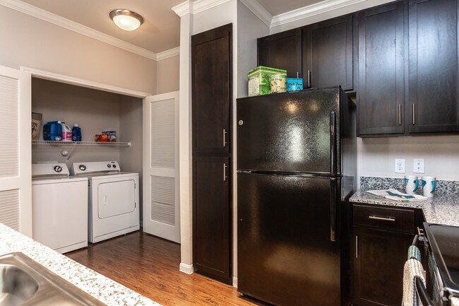 1BR, 1BA - 780SF  The Assana Kitchen & Laundry Closet - Cascadia Luxury Apartments