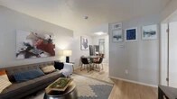 Located at 420 W Park Row Dr in Arlington, TX, this one-bedroom, one-bathroom unit offers a well-organized single-floor layout that makes efficient use of its compact footprint. Light wood-style flooring runs throughout the main living areas, creating a cohesive and clean aesthetic. The living room provides comfortable space for both relaxation and dining, with natural light entering through blinds-covered windows that overlook the exterior. A distinct dining area flows naturally from the living space, separated by a subtle architectural transition. The galley-style kitchen features warm honey-toned wood cabinetry lining both walls, white appliances including a coil-top range and refrigerator, and ample counter and storage space, making it both functional and practical. The bedroom is a well-proportioned retreat with hardwood flooring, two large windows that bring in natural light and outdoor views, and sufficient room for a full-sized bed and nightstands. The bathroom is finished with classic white square tile surrounding a full soaking tub and shower combination, maintaining a clean and simple design. Throughout the unit, neutral wall tones and consistent flooring contribute to a calm, unified atmosphere suited for everyday living.