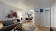 Located at 420 W Park Row Dr in Arlington, TX, this one-bedroom, one-bathroom unit offers a well-organized single-floor layout that makes efficient use of its compact footprint. Light wood-style flooring runs throughout the main living areas, creating a cohesive and clean aesthetic. The living room provides comfortable space for both relaxation and dining, with natural light entering through blinds-covered windows that overlook the exterior. A distinct dining area flows naturally from the living space, separated by a subtle architectural transition. The galley-style kitchen features warm honey-toned wood cabinetry lining both walls, white appliances including a coil-top range and refrigerator, and ample counter and storage space, making it both functional and practical. The bedroom is a well-proportioned retreat with hardwood flooring, two large windows that bring in natural light and outdoor views, and sufficient room for a full-sized bed and nightstands. The bathroom is finished with classic white square tile surrounding a full soaking tub and shower combination, maintaining a clean and simple design. Throughout the unit, neutral wall tones and consistent flooring contribute to a calm, unified atmosphere suited for everyday living.