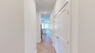 Located at 37 N York Road in Hatboro, PA, this well-appointed one-bedroom, two-bathroom unit delivers a clean, modern aesthetic throughout its single-floor layout. The open-concept kitchen and living area serves as the heart of the home, featuring crisp white cabinetry, dark granite countertops, a subway tile backsplash, stainless steel appliances, and a peninsula with an integrated sink — ideal for both cooking and casual dining. Light wood-style flooring runs seamlessly throughout, complementing the bright white walls and recessed lighting. The living room is bathed in natural light from a bank of large windows with views of the landscaped exterior and open sky. The spacious primary bedroom offers generous proportions, a window for natural light, and direct access to a walk-in closet outfitted with wire shelving systems. Two bathrooms provide added convenience — one features a tiled walk-in shower with chrome fixtures, while both include granite-topped vanities with white cabinetry and large mirrors. A private outdoor balcony overlooks the well-maintained parking area and greenery below. The unit's modern design, quality finishes, and functional layout make it a comfortable and stylish living space in the heart of Hatboro.