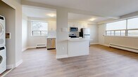 Located in Toronto's M6L neighbourhood, this well-appointed one-bedroom, one-bathroom unit offers a thoughtfully designed layout across a single floor. Light hardwood-style flooring runs throughout, creating a warm and cohesive aesthetic complemented by neutral white walls and clean white baseboards.

The open-concept kitchen is a standout feature, outfitted with crisp white shaker-style cabinetry, a white subway tile backsplash, light quartz countertops, and a full suite of stainless steel appliances including a refrigerator, electric range, over-the-range microwave, and dishwasher. A breakfast bar peninsula connects the kitchen to the dining area, enhancing the open flow of the space.

The living and dining areas are generously sized, benefiting from large windows that frame outdoor views and allow abundant natural light to fill the rooms. Baseboard heating units run beneath the windows throughout. The spacious primary bedroom offers ample room and its own large window with exterior views. Three closets provide excellent storage capacity.

The bathroom is finished with white subway tile surrounding a full soaker tub. Additional conveniences include an in-unit laundry area, a dedicated entrance, and a private balcony — ideal for enjoying outdoor views of the surrounding Toronto neighbourhood.