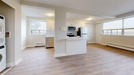 Located in Toronto's M6L neighbourhood, this well-appointed one-bedroom, one-bathroom unit offers a thoughtfully designed layout across a single floor. Light hardwood-style flooring runs throughout, creating a warm and cohesive aesthetic complemented by neutral white walls and clean white baseboards.

The open-concept kitchen is a standout feature, outfitted with crisp white shaker-style cabinetry, a white subway tile backsplash, light quartz countertops, and a full suite of stainless steel appliances including a refrigerator, electric range, over-the-range microwave, and dishwasher. A breakfast bar peninsula connects the kitchen to the dining area, enhancing the open flow of the space.

The living and dining areas are generously sized, benefiting from large windows that frame outdoor views and allow abundant natural light to fill the rooms. Baseboard heating units run beneath the windows throughout. The spacious primary bedroom offers ample room and its own large window with exterior views. Three closets provide excellent storage capacity.

The bathroom is finished with white subway tile surrounding a full soaker tub. Additional conveniences include an in-unit laundry area, a dedicated entrance, and a private balcony — ideal for enjoying outdoor views of the surrounding Toronto neighbourhood.