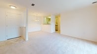 Located at 2000 Varsity Ln in Bear, Delaware, this single-floor residence offers a well-organized layout designed for comfortable everyday living. The open-concept living and dining area serves as the heart of the home, featuring plush wall-to-wall carpeting, a decorative chandelier, and sliding glass doors that lead to a private balcony with views of the surrounding greenery. Natural light flows generously throughout the space, enhancing the bright, neutral palette of white walls and light-toned flooring.

The kitchen is accessible via a pass-through counter that connects it to the dining area, providing a functional and social cooking space. Cabinetry and appliances are neatly arranged within the kitchen, which features tile flooring.

The bedrooms are carpeted and well-lit, with multiple windows inviting natural light. The primary bedroom includes a ceiling fan, an en-suite bathroom, and a vanity area with built-in cabinetry. Additional bedrooms are equally comfortable, each with ceiling fans and ample space.

Both bathrooms are finished with large-format tile flooring, single-sink vanities with light wood or white cabinetry, Hollywood-style vanity lighting, and a bathtub-shower combination. The overall ambiance is clean, bright, and move-in ready.
