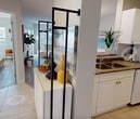 This 580 square foot apartment in London, ON, offers a thoughtfully designed living space. The open-concept layout seamlessly integrates the living, dining, and kitchen areas, creating a sense of spaciousness. The living room features a comfortable blue sofa, stylish decor, and large windows that flood the space with natural light. A sliding glass door leads to a private balcony, extending the living area outdoors.

The dining area showcases a substantial wooden table with seating for six, illuminated by a pendant light. The adjacent kitchen, though compact, is well-equipped with white cabinetry, full-sized appliances, and a breakfast bar with blue stools, perfect for casual dining or workspace.

The bedroom, measuring 140 square feet, comfortably fits a queen-sized bed and offers ample natural light through a large window. The bathroom is efficiently designed with a shower/tub combination and storage cabinets.

Throughout the apartment, wood-look flooring adds warmth and continuity. The decor style is modern and cohesive, with a color palette of blues, whites, and warm wood tones. Thoughtful touches like artwork, plants, and decorative accessories create a welcoming atmosphere in this well-designed urban living space.