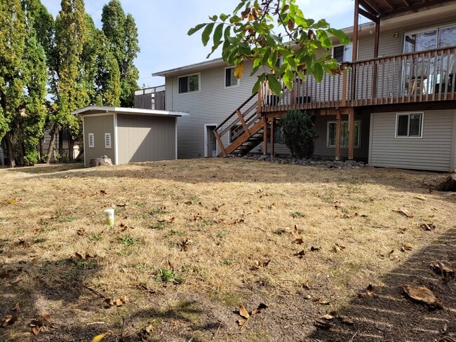 fenced back yard with shed and playhouse under deck - 5095 SW 163rd Ave