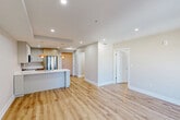 Located at 625 Jackson Ave in New Orleans, LA, this thoughtfully designed one-bedroom, one-bathroom residence offers a clean, modern aesthetic across a well-utilized single floor. Light wood-tone flooring flows seamlessly throughout, complementing the warm neutral walls and recessed lighting that brighten every room.

The open-concept living, dining, and kitchen area serves as the heart of the home. The kitchen is a standout feature, equipped with sleek flat-front cabinetry in white and natural wood tones, a striking quartz waterfall island with an undermount sink, stainless steel appliances including a gas range, microwave, dishwasher, and refrigerator, and eye-catching orange pendant lights that add a vibrant pop of color.

The living and dining areas are spacious and airy, bathed in natural light from tall, black-framed windows that frame views of the surrounding neighborhood. The bedroom is comfortably sized, featuring a ceiling fan, additional black-framed windows, and a closet for ample storage.

The bathroom is elegantly finished with large-format tile flooring, a natural wood vanity with a white countertop, and a glass-enclosed walk-in shower. A dedicated laundry area and hallway complete this well-appointed home, offering functional urban living in the heart of New Orleans.