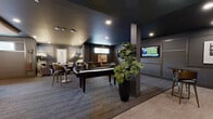 This elegantly designed amenity lounge offers a generously sized, single-floor layout encompassing nine distinct areas that together create a cohesive and upscale social environment. The space is anchored by a central game room featuring a full-size billiards table beneath a striking sputnik chandelier, complemented by wall-mounted televisions and textured accent wallcovering. Adjacent to this is a stylish bar area with high-top seating, decorative pendant lighting, and a dramatic backlit textured stone feature wall that creates an intimate, moody ambiance. A dedicated card and gaming nook offers a round felt-top table with lounge seating, wall art, and its own wall-mounted display screen. The lounge seating area is warmly appointed with a tufted sofa, velvet accent chairs, sculptural floor lamps, and curated artwork framed by wainscoting panels. Throughout the space, rich dark tones, herringbone hardwood flooring, plush carpeting, and abundant live greenery contribute to a refined, club-like atmosphere. Clerestory windows allow natural light to filter in subtly. Two ADA-accessible restrooms are finished with bold geometric and slate-toned tile work. The overall design balances luxury and functionality, making it well-suited for social gatherings and community entertainment.
