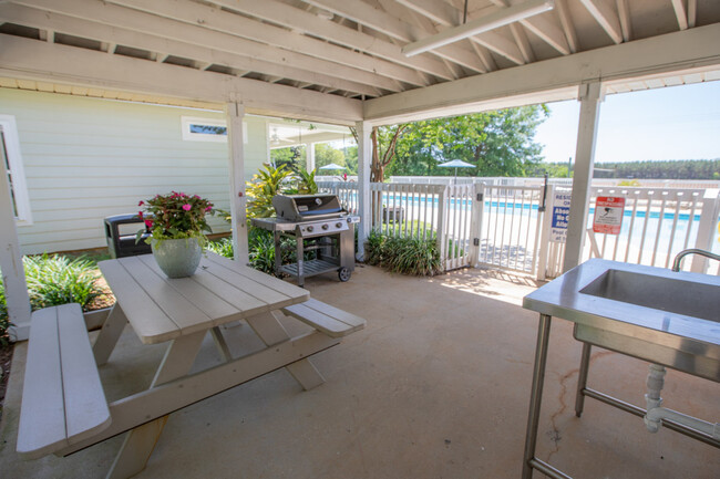 Outdoor grilling area at pool - South Pointe Apartments and Homes