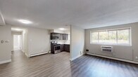 Located at 198 White Horse Pike in Collingswood, NJ, this single-floor unit offers a functional and updated living space with a clean, modern aesthetic throughout. The open-concept living and kitchen area is anchored by durable laminate hardwood flooring and neutral-toned walls that create a bright, welcoming atmosphere. A large window allows natural light to fill the living space, which also features a wall-mounted air conditioning unit and baseboard heating for year-round comfort.

The kitchen is efficiently designed in an L-shaped layout, outfitted with dark espresso cabinetry, a white subway tile backsplash, light countertops, and stainless steel appliances including a gas range with over-the-range microwave and a refrigerator. A window above the sink adds additional natural light to the space.

The bedrooms are carpeted for comfort and each feature windows that bring in natural light, along with baseboard heating and wall-mounted air conditioning units. Closet storage is also available.

The bathroom presents a clean, refined finish with marble-style tile surrounds in the tub and shower combination, light grey floor tiles, a white vanity, and brushed nickel fixtures. The entry area provides a closet and direct access to the main living space, completing this practical and updated unit.