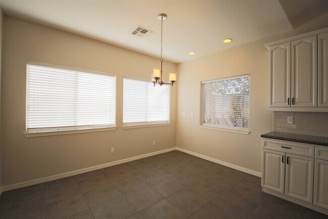 Building Photo - STUNNING single story home in serene gated...