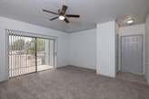 Located at 11111 Grant Rd in Cypress, TX, this single-floor residence offers a well-designed layout with a clean, modern aesthetic throughout. The open-concept kitchen is a standout feature, equipped with stainless steel appliances including a refrigerator, electric range, and dishwasher. Gray shaker-style cabinetry, light quartz countertops, and a deep single-basin sink with a contemporary pull-down faucet give the kitchen a polished, functional character. Wood-look flooring runs through the kitchen and connects seamlessly to the living area. The living space is bright and welcoming, highlighted by a ceiling fan with light fixture, crown molding details, and a sliding glass door that opens to a private balcony overlooking a tree-lined outdoor setting. The bedroom offers plush wall-to-wall carpeting, a ceiling fan, and a large window that fills the room with natural light. An additional carpeted room also features a ceiling fan and exterior-facing window. The bathroom is neatly appointed with a single-vanity featuring quartz countertops, a bold-framed mirror, wood-look flooring, and a tub-shower combination. The space also includes a dedicated laundry area, adding everyday convenience to this comfortable Cypress residence.