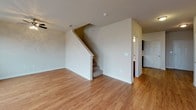 This two-story residence offers a well-designed layout across two floors, combining functional living spaces with thoughtful finishes. The kitchen serves as a central highlight, featuring rich dark-wood cabinetry, granite countertops, stainless steel appliances including a refrigerator, range, microwave, and dishwasher, plus warm hardwood-style flooring and a dedicated walk-in pantry for ample storage.

The living area is bright and open, with hardwood-style flooring, neutral tones, and a door providing access to an outdoor area, complemented by a window that brings in natural light.

Both bedrooms are carpeted and well-sized, each offering walk-in closets with built-in shelving and hanging rods for organized storage. The two full bathrooms are finished with granite countertops, dark cabinetry, hardwood-style flooring, and tub-shower combinations with tile surrounds. A half bathroom provides added convenience for guests.

Throughout the home, a cohesive neutral color palette, consistent finishes, and practical storage solutions create a comfortable and functional living environment suitable for everyday life.