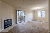 Located at 552 Rico St in Salinas, CA, this single-story, 3-bedroom, 1-bathroom home offers a practical and comfortable layout. The open living room is a standout space, anchored by a tile-surround fireplace with a sleek glass front and carpeted flooring throughout. A sliding glass door leads to an outdoor balcony, filling the room with natural light and providing outdoor access. An additional window near the dining area enhances brightness, and a pendant light fixture overhead adds a finishing touch.

The kitchen features warm wood cabinetry, tile countertops, wood-look vinyl flooring, and white appliances including a range and refrigerator, along with a window above the sink for natural light.

The primary bedroom is a well-proportioned retreat with plush carpeting, a sliding glass door to an outdoor space, and a closet with rod storage. The additional bedrooms are carpeted and include closet storage. A hallway connects the bedrooms to the shared bathroom, which is equipped with a tub-shower combo featuring sliding glass doors, wood-look flooring, and a vanity with storage. Each bedroom benefits from closet access, making this home a well-organized and functional space.