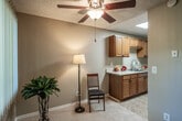 Located at 100 S Seranado St in Orange, CA, this single-floor, one-bedroom, one-bathroom residence offers a thoughtfully designed layout across a comfortable footprint. Warm neutral tones, carpet flooring throughout the main living areas, and a textured ceiling lend the space a cozy, understated character.

The living room is generously proportioned, featuring a ceiling fan with light fixture, a large window with vertical blinds that brings in natural light, and a front entry door. It flows naturally into the adjacent dining area, creating an open, connected feel. The galley-style kitchen is efficiently arranged with warm wood cabinetry, a double-basin stainless steel sink, a gas range with overhead microwave, and tile flooring — offering ample counter space and storage.

The bedroom is a comfortable, well-sized room with soft carpet, neutral walls, mirrored sliding closet doors, and sliding glass doors that open directly to a private outdoor patio. This indoor-outdoor connection adds a welcoming sense of openness. The bathroom features a full tub/shower combo, a wide vanity with generous storage, tile flooring, and a window for natural light. Additional storage is provided by three closets distributed throughout the unit, accessible via a connecting hallway.