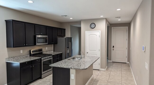 Kitchen, stainless steel appliances (d/w in island), pantry, dining room (behind pantry) - 38221 W San Ildefanso Ave