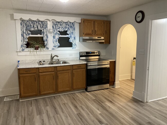 Spacious kitchen with new flooring, countertops, and stainless steel range/oven! - 449 Brush Mountain Rd