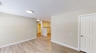 Located at 1008 Rucker St in Greensboro, NC, this single-story, one-bedroom, one-bathroom unit offers a clean and functional layout with modern updates throughout. Light wood-style flooring runs continuously across the entire space, complemented by neutral beige-toned walls and crisp white trim, creating a cohesive and welcoming atmosphere.

The combined kitchen and living area forms the heart of the home. The kitchen is well-appointed with white shaker-style cabinetry, marble-patterned countertops, a stainless steel sink, and a full suite of stainless steel appliances including a refrigerator, electric range, over-the-range microwave, and dishwasher. Flush-mount lighting and a skylight brighten the kitchen, enhancing the clean aesthetic.

The living area provides an open, versatile space with two doorways offering connectivity to the rest of the unit. The bedroom is comfortably sized, featuring a window with blinds that allows natural light and outdoor views of surrounding greenery. A dedicated closet offers convenient storage.

The bathroom includes a walk-in shower with grab bars, a single-handle fixture, and a floating wood-toned vanity with a white countertop surface. Throughout the unit, the design emphasizes simplicity, functionality, and a move-in-ready condition.