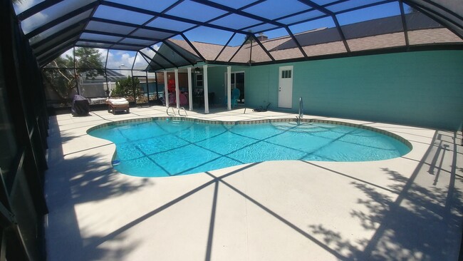 Solar heated pool under screen house - 47 Sea Island Dr N