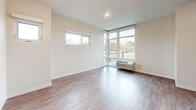 Located at 510 State Ave NE in Olympia, Washington, this three-bedroom, four-bathroom residence spans three floors, offering a well-organized and functional layout throughout. The main living level hosts an open-concept kitchen and living area anchored by a peninsula with white quartz countertops, a stainless steel sink, and pendant lighting overhead. The kitchen is fully equipped with stainless steel appliances, including a refrigerator, range, and dishwasher, complemented by gray shaker-style cabinetry. Light wood-style flooring flows throughout all levels, adding warmth and continuity to the space. Two staircases connect the floors, facilitating smooth circulation throughout the home. The bedrooms are bright and airy, several featuring large corner windows that frame views of the surrounding Olympia neighborhood and fill the rooms with natural light. The spacious primary bedroom includes a closet and direct access to a private bathroom. The four bathrooms are finished consistently with light gray cabinetry, white countertops, and clean fixtures. A utility room and hallway round out the practical spaces within the home. The overall aesthetic is modern and neutral, with crisp white walls, clean lines, and quality finishes throughout.