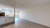 Located at 5353 Baltimore Dr in La Mesa, California, this one-bedroom, one-bathroom residence offers a well-organized single-level layout. The open-concept living and kitchen area is bright and airy, featuring light wood-look flooring, neutral white walls, and a textured ceiling. A sliding glass door leads to a private balcony, filling the space with natural light. The kitchen is well-appointed with white shaker-style cabinetry, a subway tile backsplash, stainless steel appliances including a refrigerator, electric range, and over-the-range microwave, plus a wall-unit air conditioner for year-round comfort. The spacious bedroom is carpeted and receives natural light through a large window with views of surrounding greenery. It features a walk-in closet equipped with built-in shelving and a hanging rod, providing generous storage. The bathroom includes a full tub-shower combination with clean, white finishes and modern chrome fixtures. Throughout the residence, the clean, neutral color palette and updated finishes create a cohesive and functional living environment suited for comfortable everyday living in the heart of La Mesa.