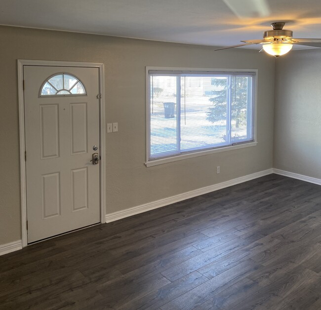 Large living room with picture window. - 4651 Luann Ave