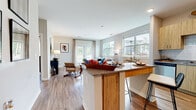 Located at 7326 Wallace Rd in Charlotte, NC, this single-floor residence offers a thoughtfully designed open-concept layout that seamlessly connects the kitchen, dining, and living areas. The kitchen is equipped with light wood cabinetry, granite countertops, a white tile backsplash, and a full suite of stainless steel appliances, including a refrigerator, range, microwave, and dishwasher. A peninsula with bar seating provides additional workspace and casual dining options. The living room is bright and welcoming, featuring large windows and French doors that invite abundant natural light and offer outdoor views. Wood-look flooring flows consistently throughout the entire residence, lending warmth and continuity to the space. The bedrooms are generously proportioned, each with large windows, ceiling fans, and ample room for furnishings. The primary bedroom features a walk-in closet and an en-suite bathroom with granite vanity countertops and wood-tone cabinetry. Additional bathrooms mirror this refined aesthetic, with one offering a soaking tub and shower combination. Neutral wall tones and recessed lighting throughout contribute to the clean, contemporary ambiance of this well-appointed Charlotte residence.