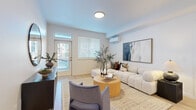 Located in Vancouver, WA, this thoughtfully designed 2-bedroom, 2-bathroom residence offers a bright and modern living experience across a single floor. The open-concept kitchen and living area serves as the heart of the home, featuring gray shaker-style cabinetry, stainless steel appliances, a white quartz island with bar seating, and sleek pendant lighting — ideal for both everyday cooking and casual entertaining. Light wood-style flooring runs throughout the main areas, enhancing the airy, contemporary feel.

The living room is bathed in natural light from large windows and a glass exterior door, and is equipped with a wall-mounted mini-split HVAC unit for year-round comfort. The primary bedroom offers a generous footprint with a large window and ample natural light, while the second bedroom features carpeted flooring and its own window. Both bathrooms are finished with gray vanity cabinetry and white countertops; one includes a full tub-shower combination. A hallway connects the private quarters to the main living space, and a dedicated closet provides additional storage. The overall aesthetic is clean, neutral, and modern throughout.