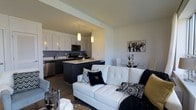 Located at 4328 Ridge Avenue in the East Falls neighborhood of Philadelphia, PA, this single-floor residence offers a sleek, modern living experience defined by thoughtful design and high-quality finishes throughout. The open-concept layout seamlessly connects the kitchen, dining, and living areas, creating a bright and cohesive space ideal for both everyday living and entertaining. The contemporary kitchen is outfitted with white flat-panel cabinetry, a dark tile backsplash, stainless steel appliances including a dishwasher and microwave, and a dark-toned center island with light countertops that doubles as a breakfast bar. Pendant lighting over the island adds warmth and visual interest to the space. The living area flows naturally from the kitchen and features dark hardwood-style flooring that runs throughout, contributing to a clean, unified aesthetic. Neutral walls provide a versatile backdrop, complemented by the bold contrast of the black and white design accents visible throughout the space. A dedicated dining area rounds out the open floor plan, offering a comfortable space for meals. The overall ambiance is modern, refined, and move-in ready, making this Ridge Avenue residence a compelling option in one of Philadelphia's vibrant neighborhoods.