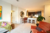 Located at 900 Radius Way in Newport News, Virginia, this single-floor residence offers a well-designed layout with thoughtfully appointed living spaces throughout. The kitchen is a standout feature, showcasing rich dark cabinetry, light quartz countertops, a double-basin sink, and a full suite of stainless steel appliances including a range, microwave, and refrigerator. A peninsula with bar seating provides both additional prep space and a casual dining option, while tile flooring ties the area together with a clean, polished look. The living area is bright and welcoming, featuring plush carpeting, large windows that bring in natural light, and French doors that open to a private balcony with outdoor views. A second sitting area offers additional flexible living space, also carpeted and filled with natural light from multiple windows. The bedroom is a calm retreat with soft carpeting, generous storage, and a wide wall mirror that enhances the sense of space. The bathroom features the same dark cabinetry as the kitchen, a stone-topped vanity, tile flooring, and a shower-tub combination. A carpeted hallway with closet access connects the rooms, completing this well-organized and stylish single-level home.