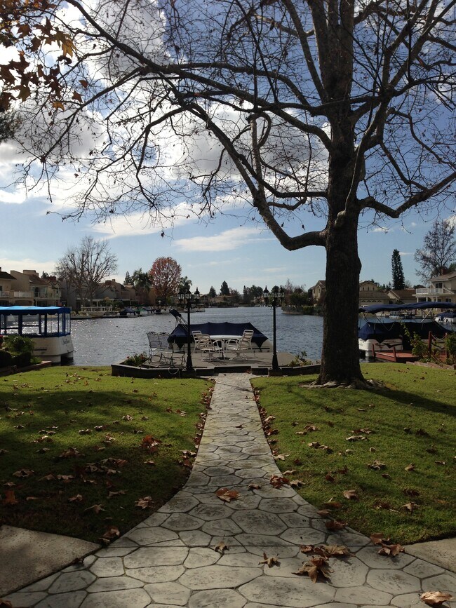 LOVELY WATERFRONT HOME WITH PRIVATE DOCK.DOWNSTAIRS BEDROOM AND BATH. 2 CAR ATTACHED GARAGE. - 24466 Toledo Ln