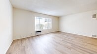 Located in the desirable Westside neighborhood of Los Angeles, this 1-bedroom, 2-bathroom unit at 1319 Wellesley Ave offers a clean, functional layout finished with light wood-style flooring throughout. The open living room is bright and airy, featuring large windows that invite natural light and views of the surrounding neighborhood, along with a wall-mounted A/C unit for year-round comfort. A textured ceiling runs through the main living areas, adding a classic touch to the neutral palette.

The galley-style kitchen is well-appointed with white shaker cabinetry, marble-look countertops, a stainless steel sink, and a full suite of stainless steel appliances including a gas range, microwave, and refrigerator.

The spacious bedroom offers a textured ceiling, a window for natural light, and direct access to a dedicated walk-in closet with built-in shelving and hanging rods. The unit includes two bathrooms: one features a full soaking tub with white subway tile surround, while the second offers a wide vanity with white cabinetry, a stone-top counter, and a large mirror — ideal as an en-suite. Light wood flooring extends seamlessly throughout both bathrooms, tying the entire unit together.