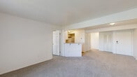 Located at 8310 Bridgeway Blvd in Fort Wayne, Indiana, this single-floor, 2-bedroom, 1-bathroom residence offers a practical and well-organized layout designed for comfortable everyday living. The open living area is spacious and bright, finished with neutral-toned carpet and clean white walls that lend a light, airy ambiance throughout. A peninsula counter connects the living space to the kitchen, creating an open flow ideal for both cooking and entertaining. The kitchen features white shaker-style cabinetry, light granite-look countertops, wood-look vinyl flooring, and white appliances including a gas range and refrigerator. Both bedrooms are carpeted and filled with natural light from large windows with exterior views. Each bedroom includes a dedicated closet with built-in shelving, providing ample storage. The primary bedroom is generously sized and offers direct access to the hallway. The full bathroom is finished with wood-look vinyl flooring and includes a bathtub with tile surround and clean, minimal fixtures. A hallway connects the main living spaces, and the entry features a paneled door. The overall aesthetic is clean, neutral, and functional, making this a well-appointed residence in Fort Wayne.