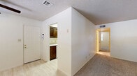 Located at 200 Moonglow St in Alamogordo, New Mexico, this single-story, 2-bedroom, 1-bathroom home offers a practical and efficient layout designed for comfortable everyday living. The entryway opens to a combined living and dining area, where light wood-style flooring transitions to plush carpet, and windows with blinds allow natural light to fill the space. The front door is flanked by a window that frames views of the surrounding neighborhood. The kitchen features dark wood cabinetry with ample storage, a double-basin sink with a light countertop, and light wood-look tile flooring. A full-size refrigerator is included. A hallway connects the main living areas to the two bedrooms and shared bathroom. Both bedrooms are carpeted and finished with neutral walls and textured ceilings; the primary bedroom offers a generous footprint, while the secondary bedroom includes a ceiling fan with light and a window for natural ventilation. The full bathroom is appointed with a vanity featuring dark wood cabinetry, a single-basin sink, tile flooring, and a tub-shower combination. Throughout the home, textured ceilings and a consistent neutral color palette create a clean, cohesive aesthetic.
