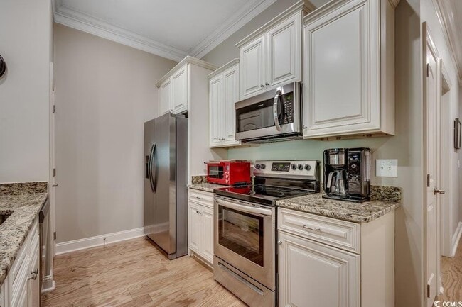 Great galley kitchen with stainless appliances - 144 Puffin Dr