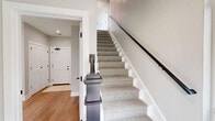 Located at 5424 Old Orchard Road in Skokie, IL, this contemporary three-story townhome offers four bedrooms and four bathrooms across a well-designed layout. The exterior features a modern façade with a mix of gray siding and wood-tone accents, complemented by private balconies and an attached garage on the ground level.

The main living floor is the heart of the home, featuring an open-concept living room bathed in natural light from large windows. Light hardwood flooring flows throughout, creating a warm and cohesive aesthetic. The living area connects seamlessly to the kitchen, which is outfitted with gray shaker-style cabinetry, crisp white quartz countertops, stainless steel appliances, a matte black faucet, and a subway tile backsplash. A kitchen island with a built-in microwave drawer adds both function and style.

The bedrooms are calm and inviting, dressed in soft neutral tones with natural light filtering through well-placed windows. The spacious primary bedroom includes a wall-mounted TV and direct access to a private area. The bathrooms are elegantly finished, featuring dark-framed vanities with lit mirrors and glass-enclosed showers, while additional bathrooms offer full soaking tub and shower combinations with crisp white tile and matte black fixtures throughout. Recessed lighting and clean white trim complete the polished, modern feel of this thoughtfully designed home.